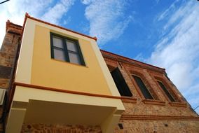 colorful balcony on old brick facade, greece, chios