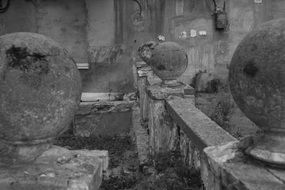 black and white photo of ruins and stone balls