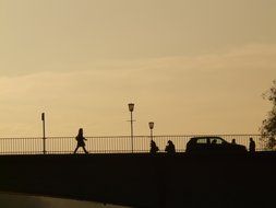 people and the car on the bridge