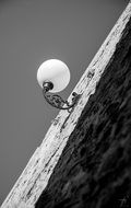 black and white picture of a round wall lamp