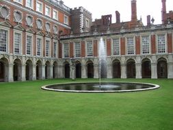 Beautiful palace courtyard with the fountain and gras