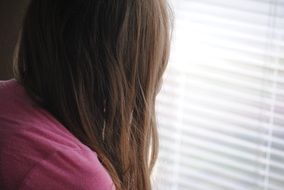 girl looks out the window