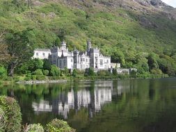 monastery among green trees near the lake