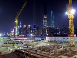 Panoramic view of a construction site in the middle of Shanghai at night