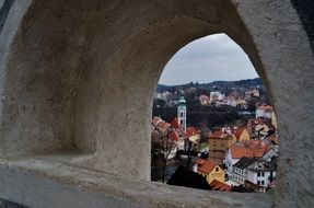 view of the city through a stone window