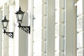 vintage wrought iron lanterns on stone wall, uk, england