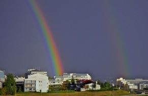 rainbow over houses after rain