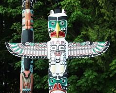 two colorful totem poles at greenery, canada, british columbia, vancouver