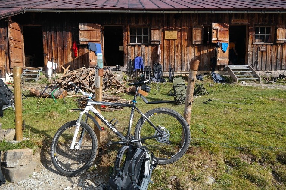 Mountain bike on a halt in the background of a log house