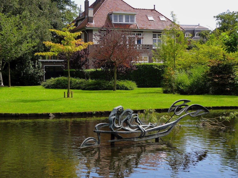 Beautiful sculpture on a lake among beautiful plants in Gouda, the Netherlands