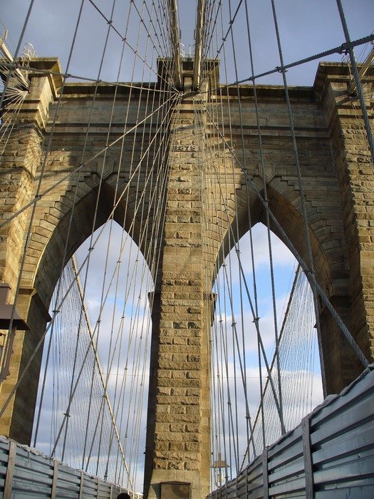 archway of Brooklyn bridge in New York