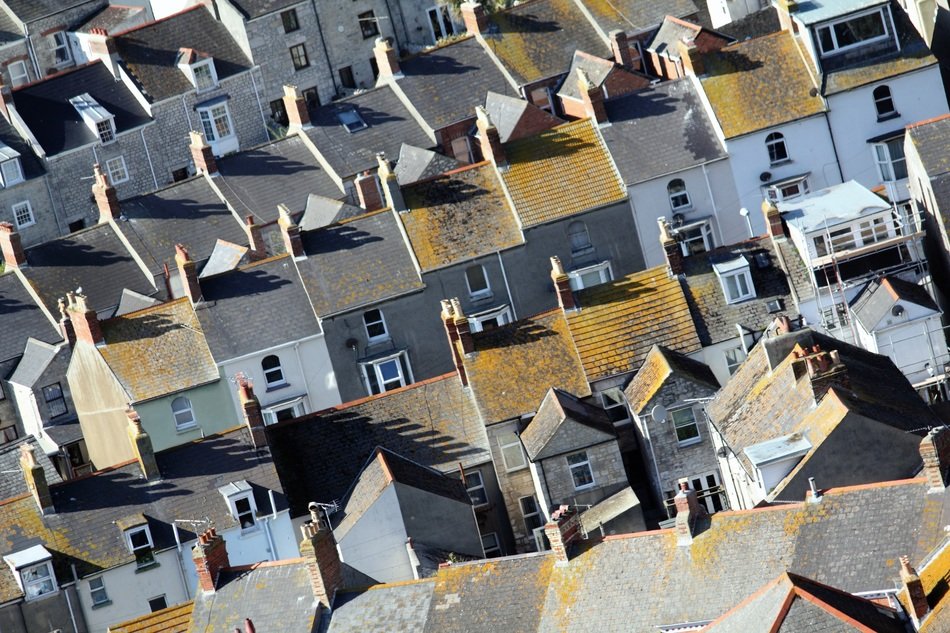 panorama of small roofs of houses with chimneys