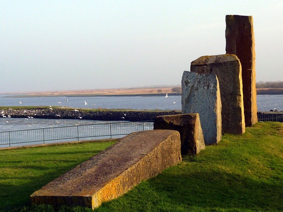 group of scenic big stones on hill in front of sea