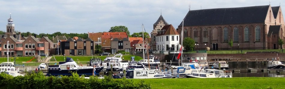buildings and boats at port, netherlands, vollenhove
