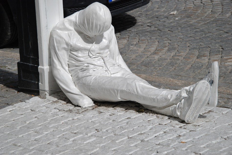 white statue of a man on the street