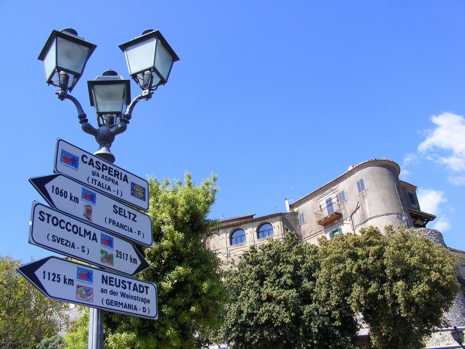 signposts on a lantern wall in Italy