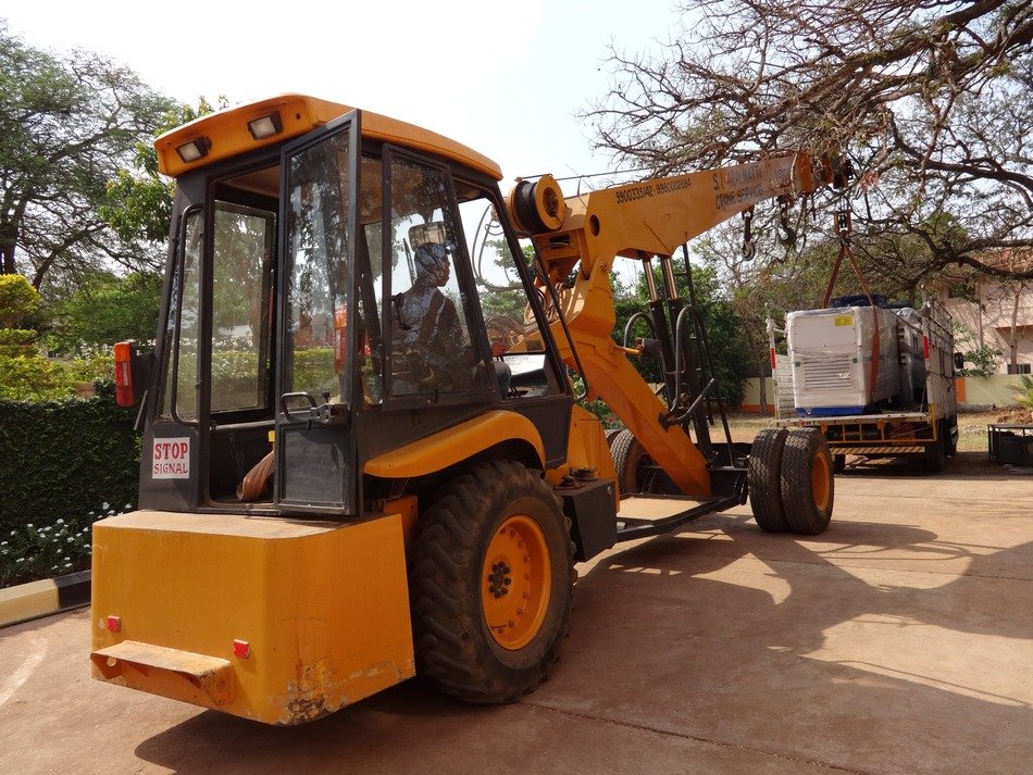 yellow crane lifts cargo in India