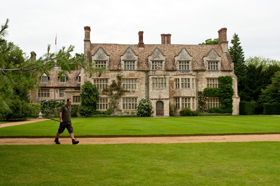gardener runs along the path in front of the estate in Cambridgeshire, England