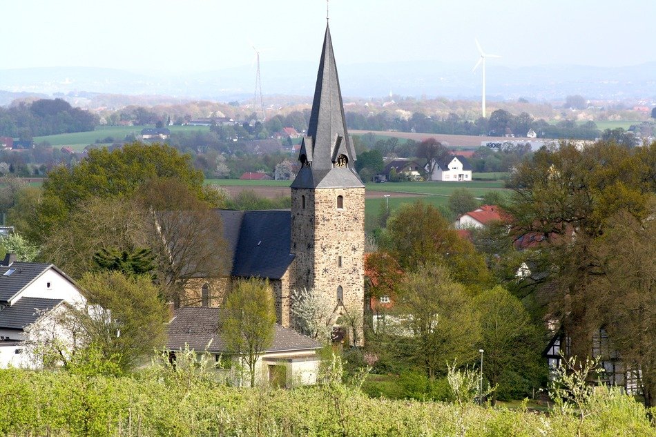 church among trees in a valley in westphalia