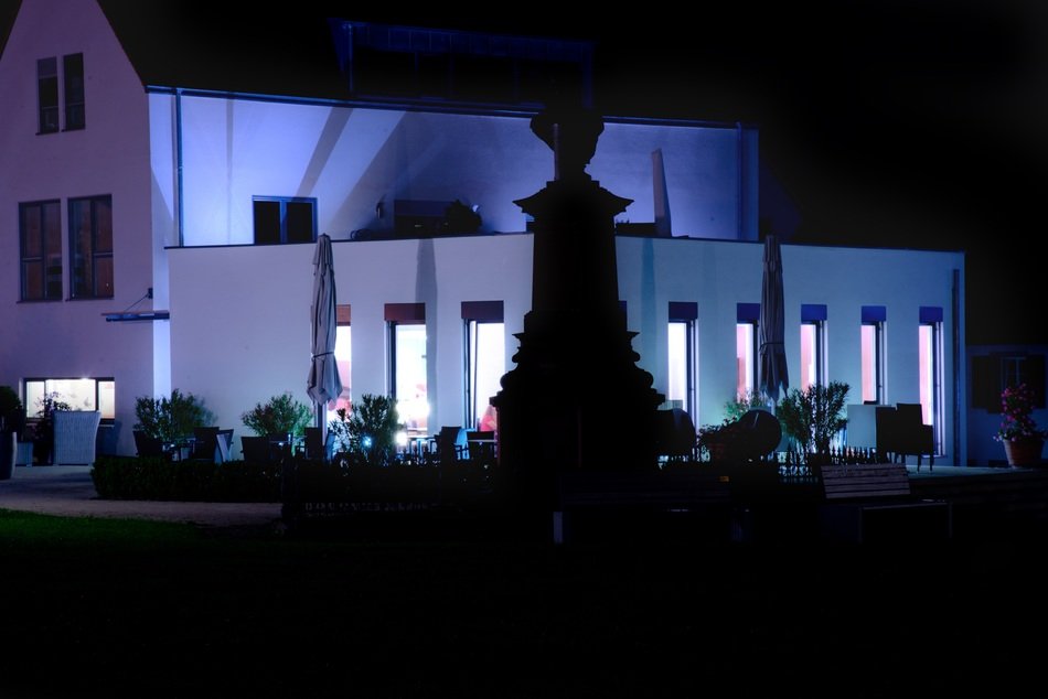 Modern faÃ§ade of the villa at night with lighting