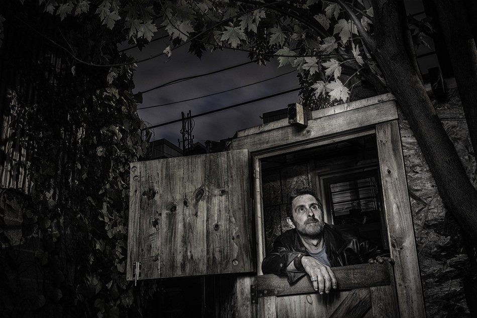 Black and white photo of the man in the tree house