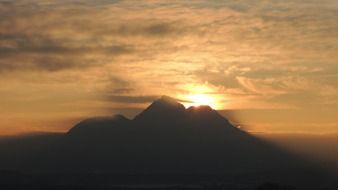 distant view of a bright sunset in the mountains