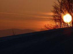 orange sun at sunset in the mountains