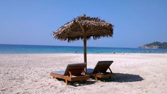 umbrella with deckchairs on the beach