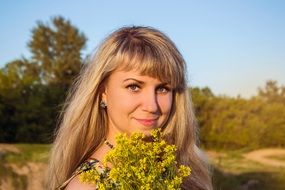 blonde with a bouquet of wildflowers