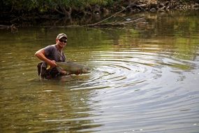 fisherman with salmon in hands