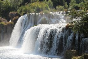 beautiful waterfall falls into the water in nature
