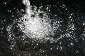 jet of water falls in pool