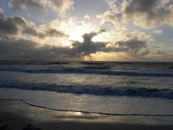 surf waves on the beach during sunset