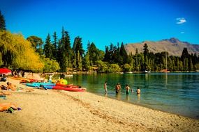 beach on a lake near queenstown in new zealand