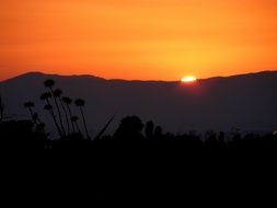 light of a orange sunset over the mountains