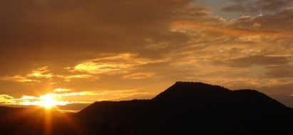 orange sunset on the horizon over the mountains