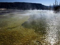 steam over the water in Yellowstone National Park, Wyoming, USA