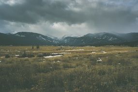 thunderclouds over a mountain valley