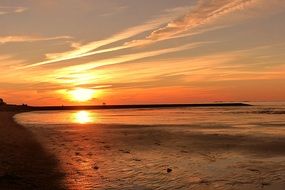 orange sunset over the beach in the North Sea