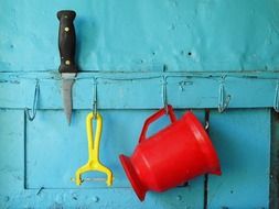 kitchen utensils on a blue wall