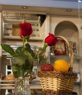 fruit basket and roses in a vase