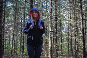 female hiker with backpack in the forest