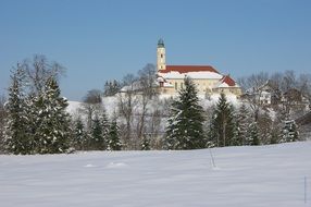 photo of monastery in the forest in winter