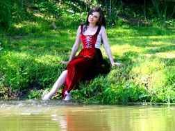 girl sitting on the lakeside