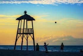 Observation tower and people on the beach in the evening