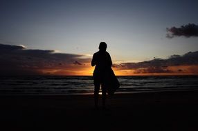 silhouette of a man on the beach at sunset