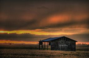 landscape of barn on a farm during sunset