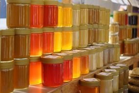 Red yellow honey jars on shelves