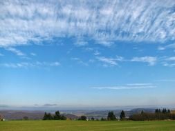 landscape of clouds in the blue sky over the meadow