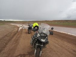 Black motorcycle on the coast under cloudy sky in Pery